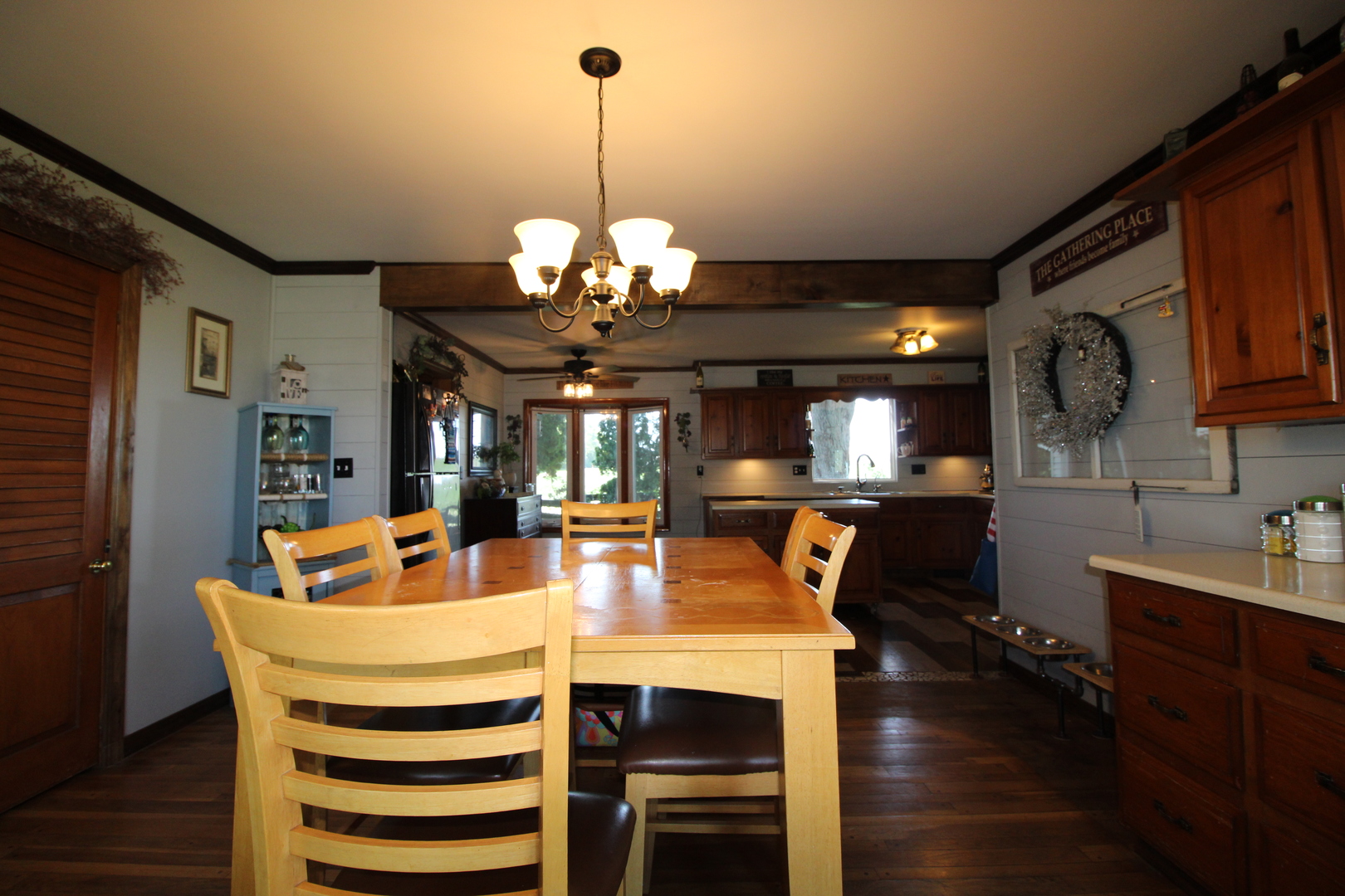 9033 Crego Road Waterman, IL 60556 - Photo 5 of 21 a view of a dining room with furniture a chandelier and wooden floor