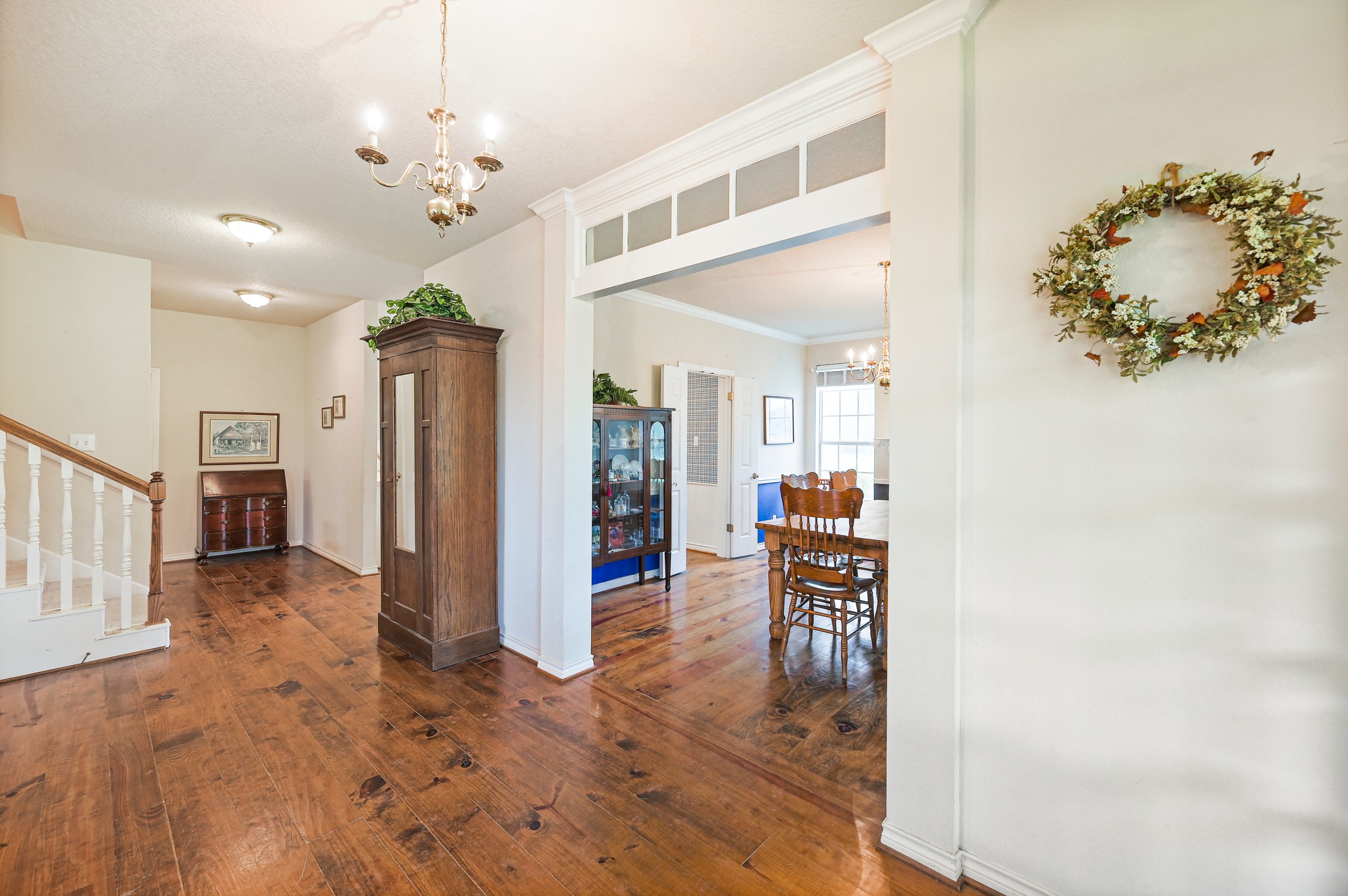 364 Nameless Road Driftwood, TX 78619 - Photo 11 of 32 Rich hardwood flooring guides you through this elegant entryway, past the staircase, and towards a welcoming dining area.