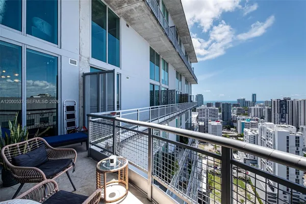 a balcony with table and chairs