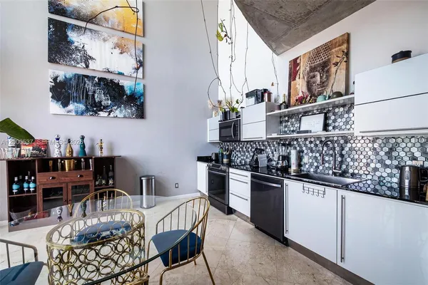 a kitchen with a table and chairs in it