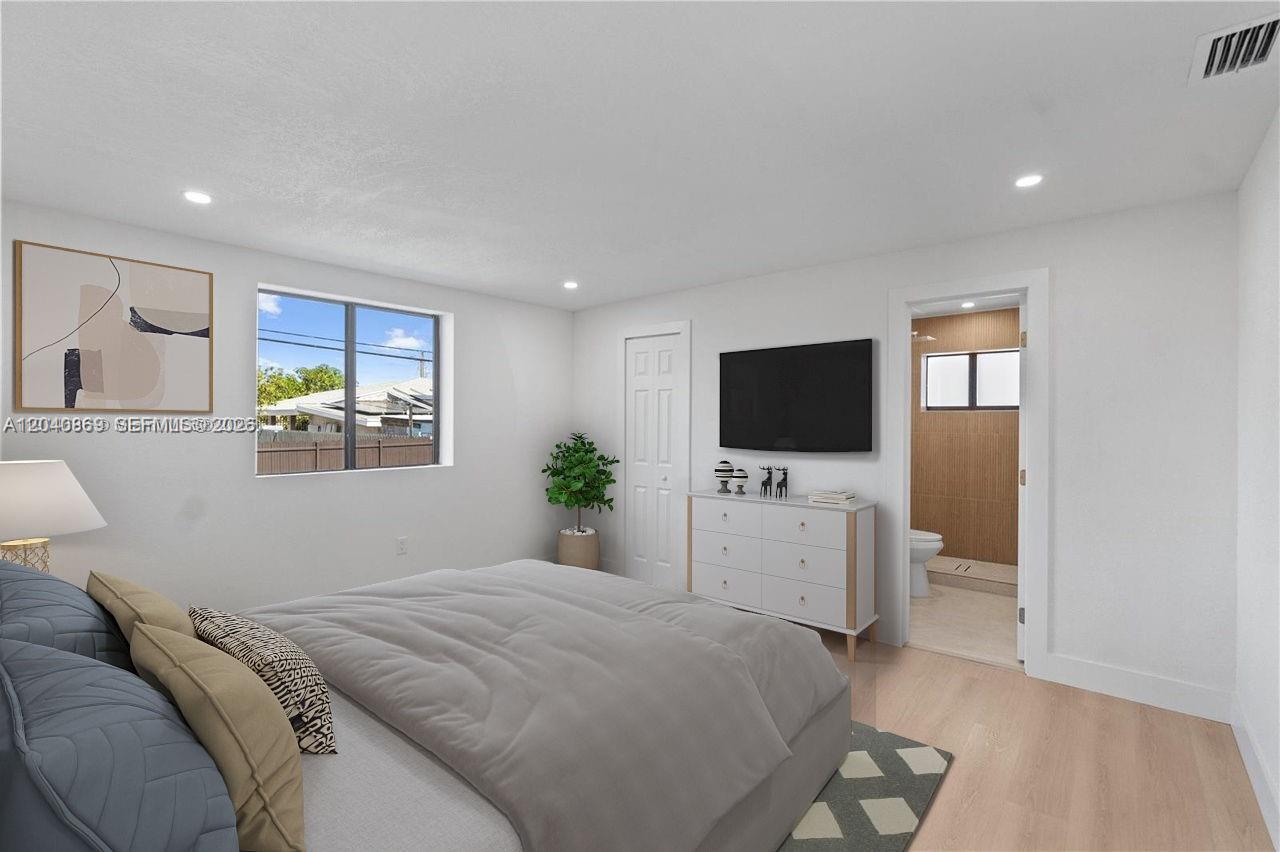 31 West 64th Street Hialeah, FL 33012 - Photo 31 of 49 a bedroom with a bed and a flat screen tv