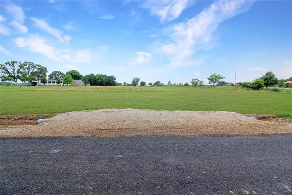 a view of a green field with clear sky