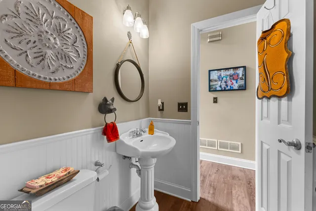 a kitchen with stainless steel appliances granite countertop a table chairs sink and cabinets