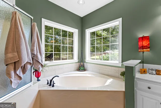 a front view of a house with yard and green space