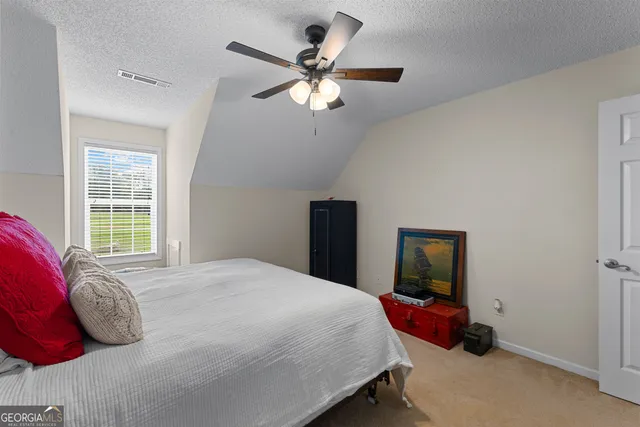 a view of a house with a garden and plants