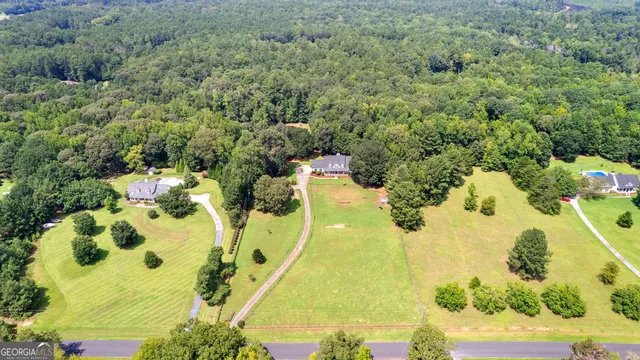a view of a hallway with wooden floor and a living room