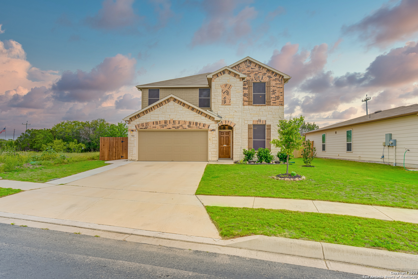 9818 Harbor Mist Lane Converse, TX 78109 - Photo 1 of 1 a front view of a house with a yard and garage