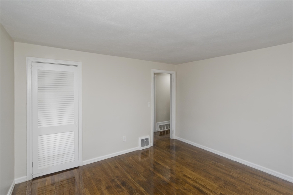99 Massreco Street Springfield, MA 01109 - Photo 13 of 40 a view of an empty room and wooden floor