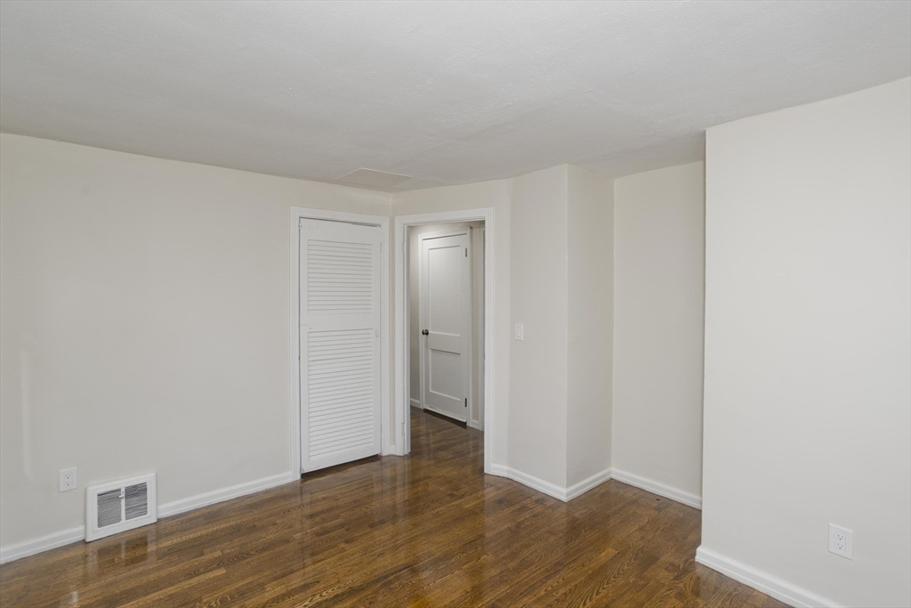 99 Massreco Street Springfield, MA 01109 - Photo 15 of 40 a view of an empty room with wooden floor