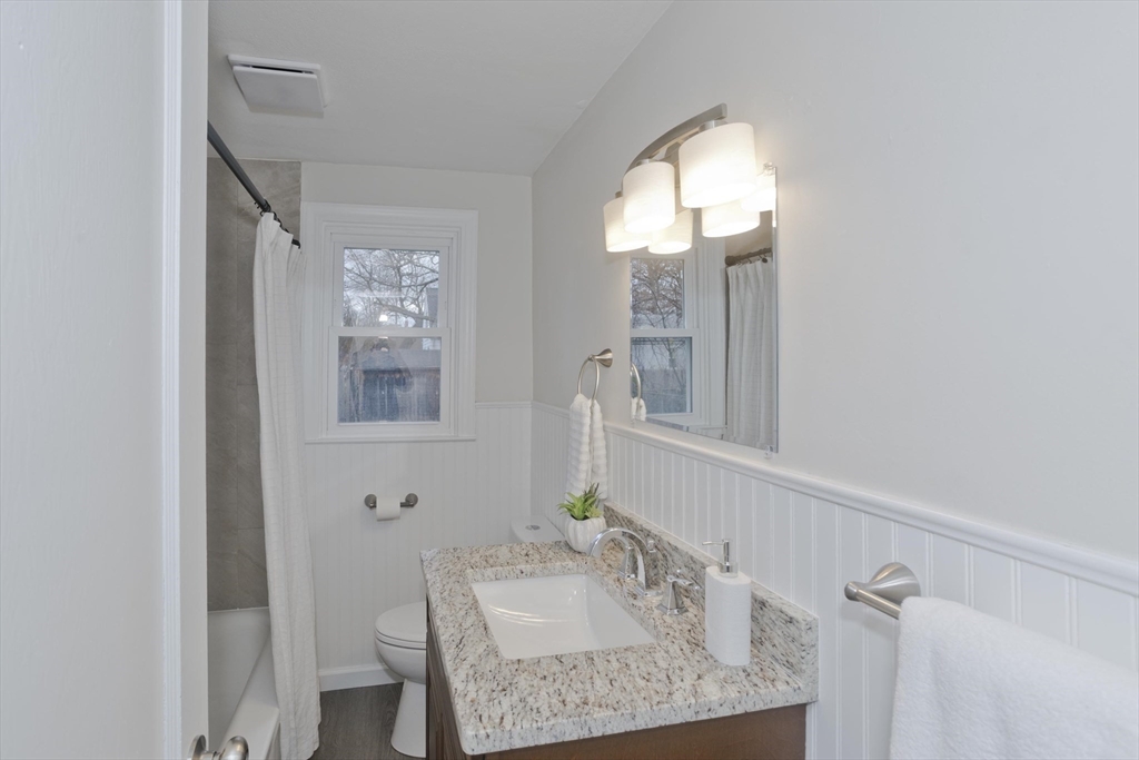 99 Massreco Street Springfield, MA 01109 - Photo 16 of 40 a bathroom with a granite countertop sink and a mirror