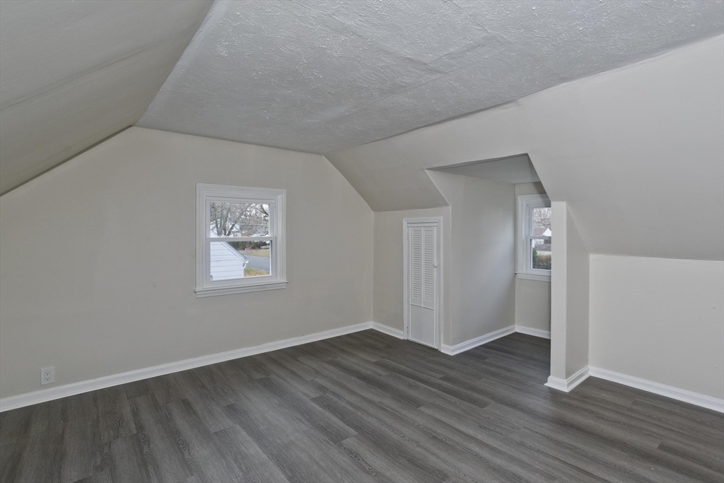 99 Massreco Street Springfield, MA 01109 - Photo 20 of 40 an empty room with wooden floor and windows