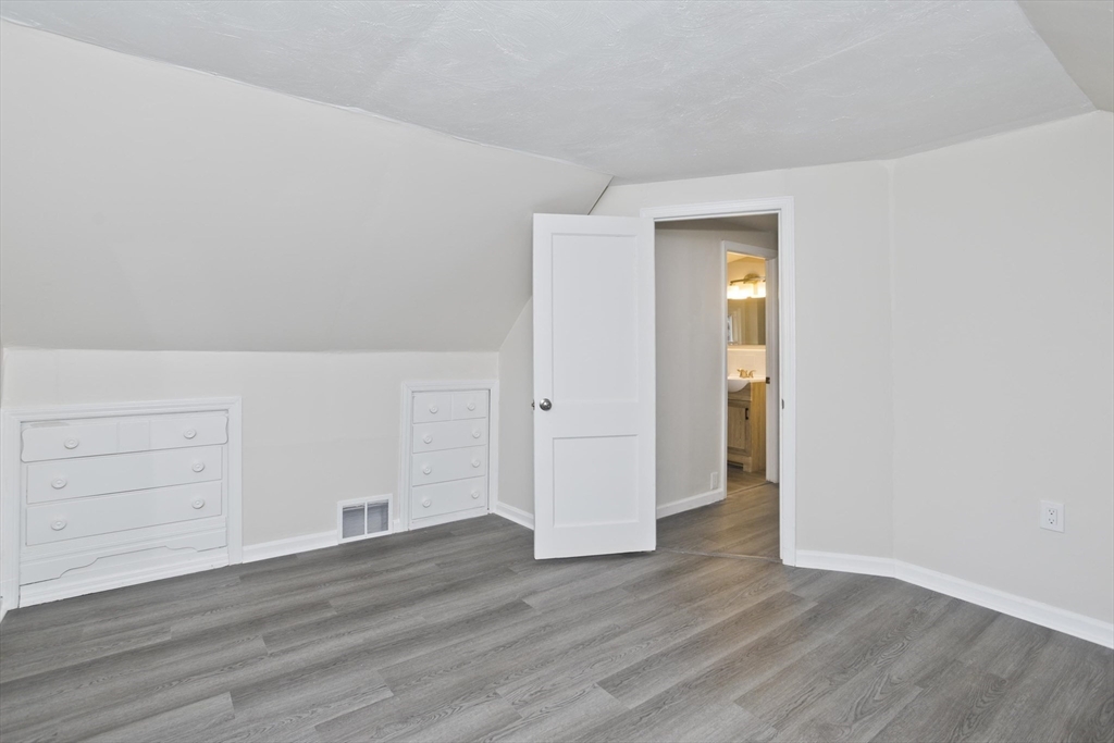 99 Massreco Street Springfield, MA 01109 - Photo 23 of 40 an empty room with wooden floor