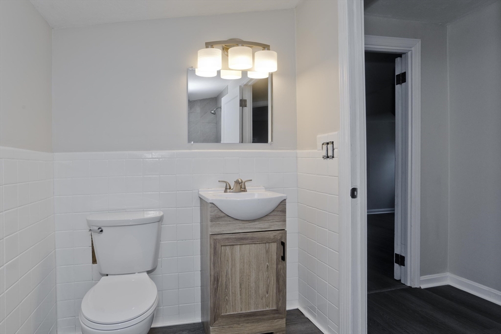 99 Massreco Street Springfield, MA 01109 - Photo 24 of 40 a bathroom with a toilet a sink and mirror