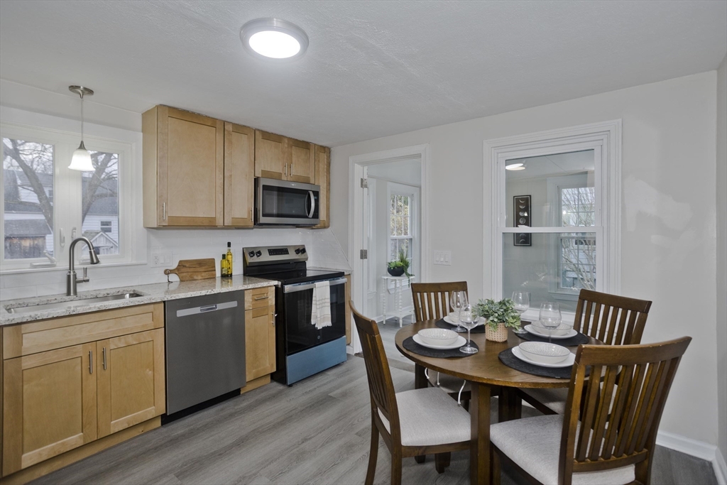 99 Massreco Street Springfield, MA 01109 - Photo 9 of 40 a view of a dining room with furniture and wooden floor