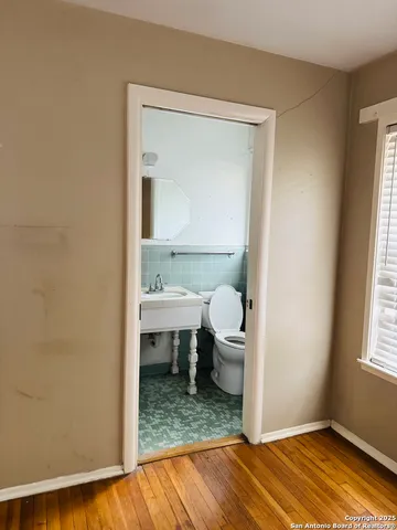 a bathroom with a granite countertop sink a mirror and shower
