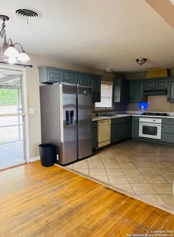 a kitchen with stainless steel appliances granite countertop a refrigerator and a sink