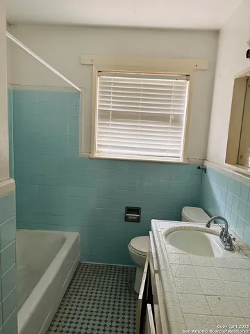 a bathroom with a sink a toilet and bathtub