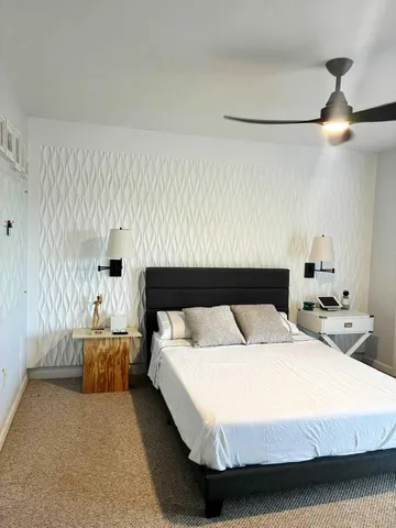 a bedroom with a bed and window