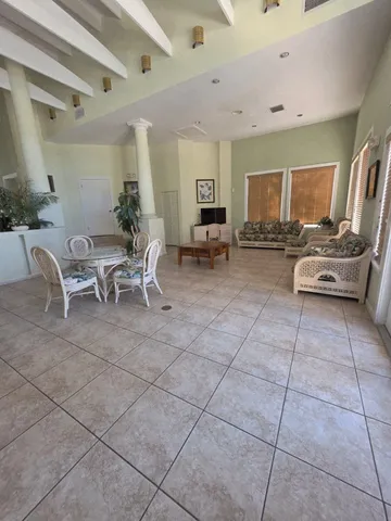 a living room with furniture a table and chairs