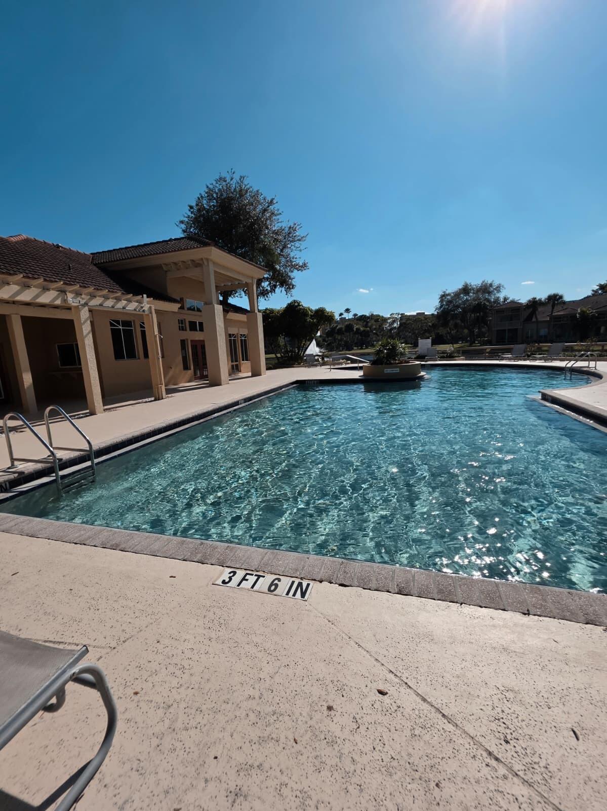 4863 Via Palm Lakes, Unit 812 West Palm Beach, FL 33417 - Photo 21 of 27 a front view of a house with a yard