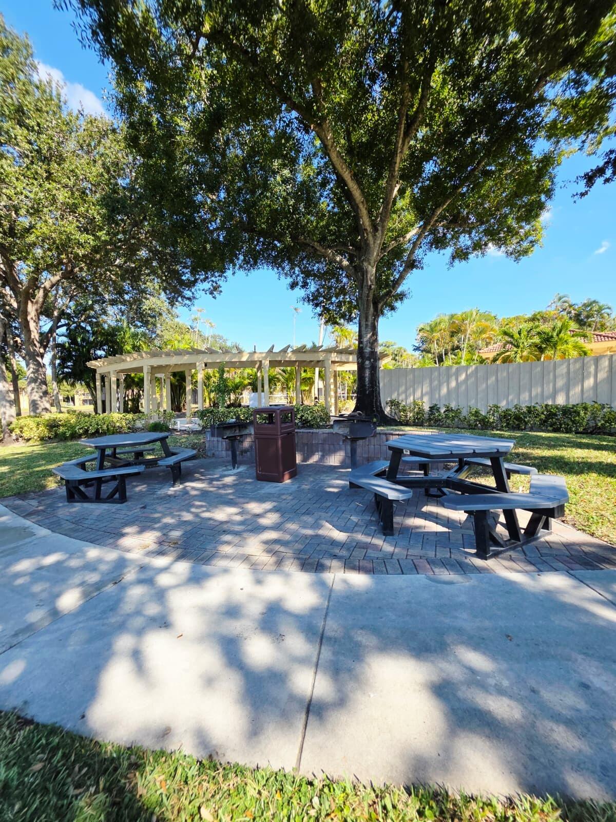 4863 Via Palm Lakes, Unit 812 West Palm Beach, FL 33417 - Photo 24 of 27 a view of a house with yard and sitting area