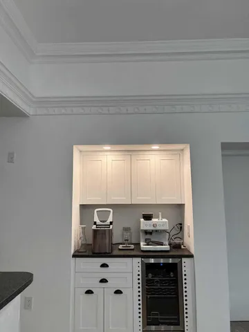 a kitchen with granite countertop a sink cabinets window and stainless steel appliances