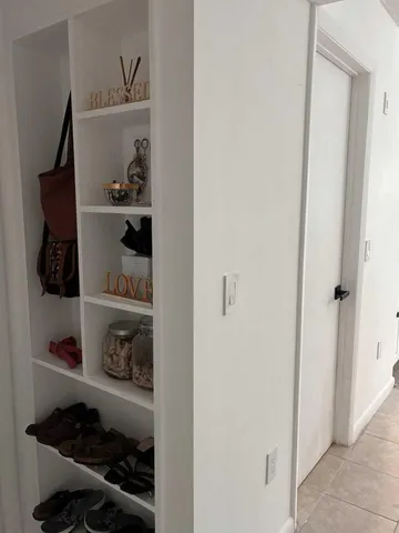 a room with a wooden floor and shoes