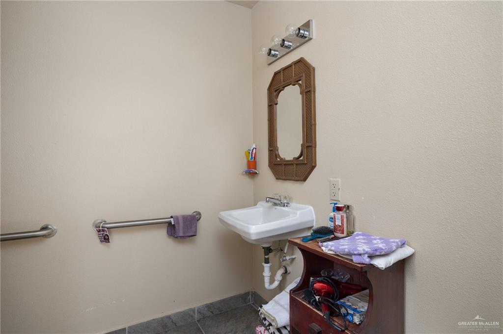 705 Garcia Street Roma, TX 78584 - Photo 12 of 23 a bathroom with a sink and a mirror