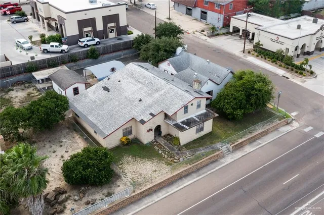 an aerial view of a house with a yard and sitting area
