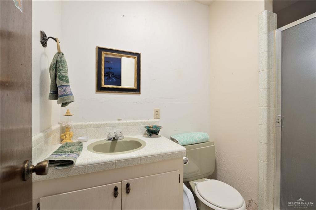 705 Garcia Street Roma, TX 78584 - Photo 10 of 23 a bathroom with a toilet sink and mirror