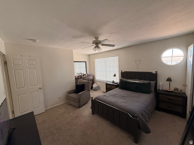 183 East 820 South Centerville, UT 84014 - Photo 9 of 14 Carpeted room featuring a ceiling fan, a rectangular window with blinds, and a distinctive oval window