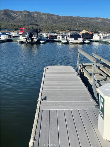 a view of roof deck with outdoor seating and lake view