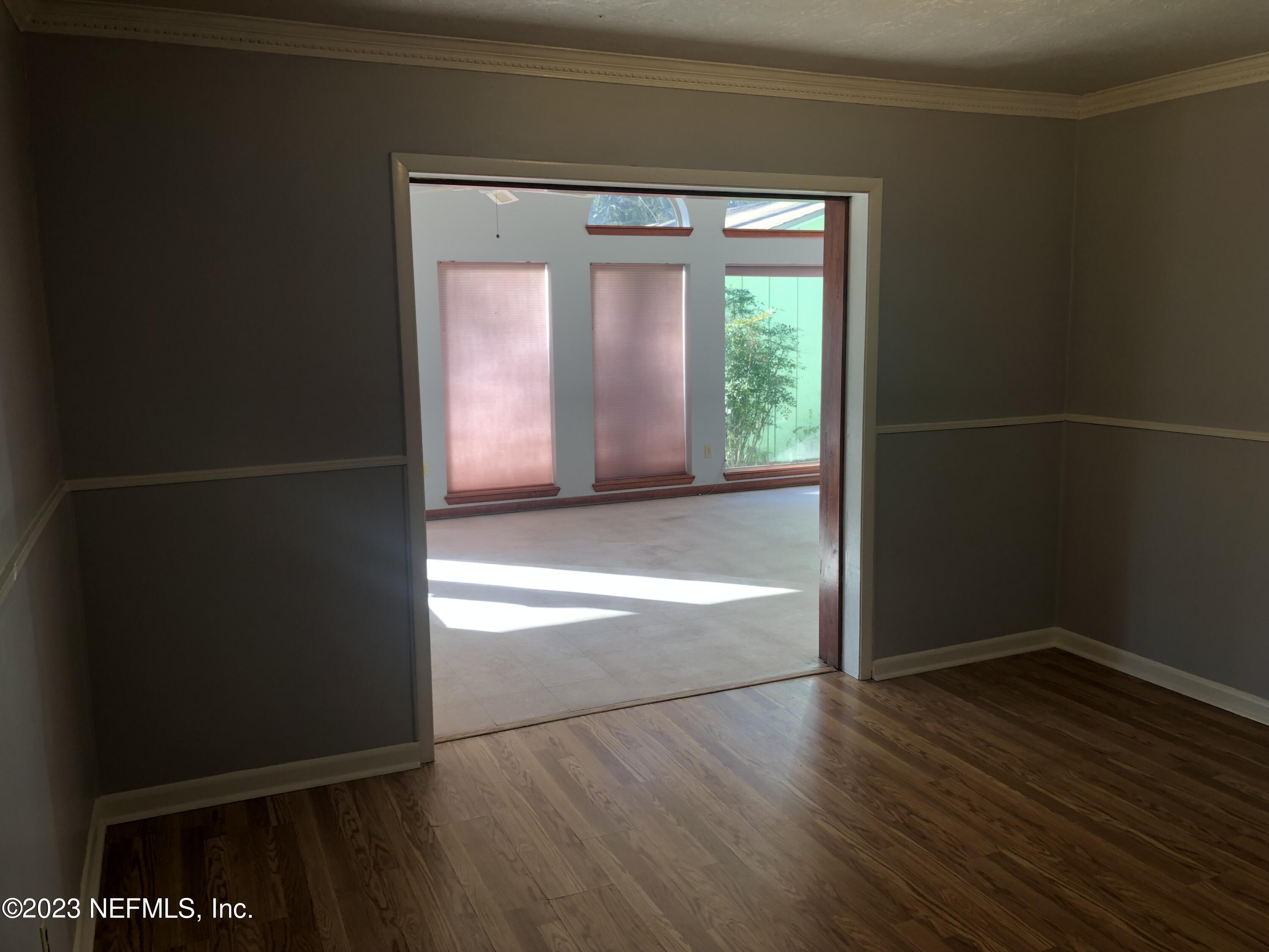 326 Blake Avenue Orange Park, FL 32073 - Photo 20 of 25 an empty room with wooden floor and windows