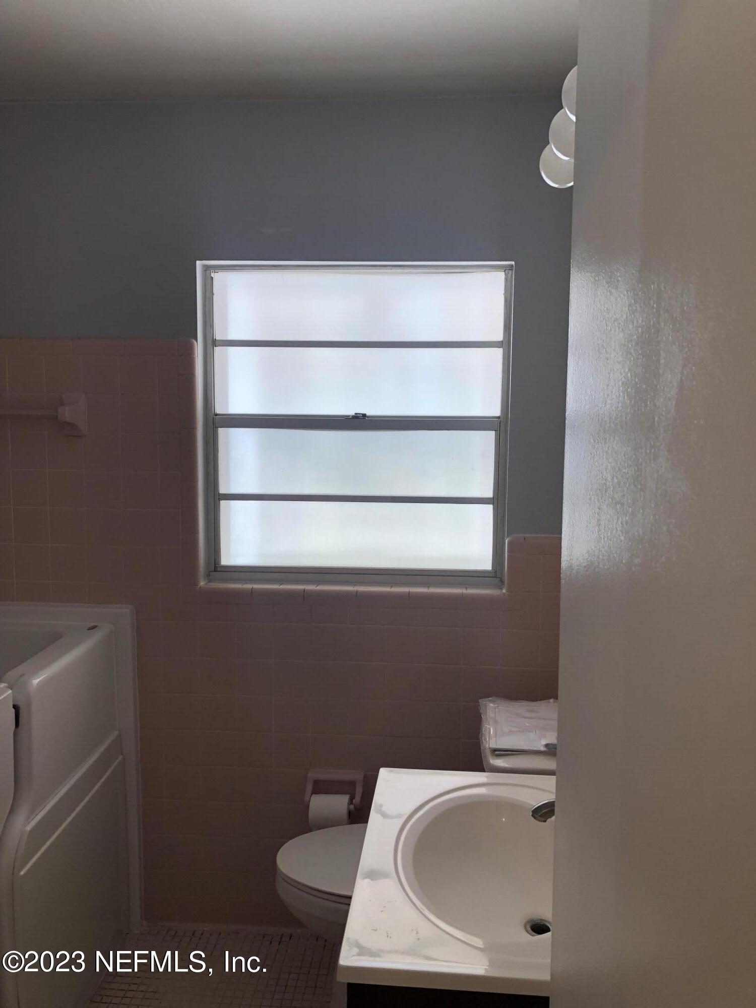 326 Blake Avenue Orange Park, FL 32073 - Photo 22 of 25 a bathroom with a sink window and toilet