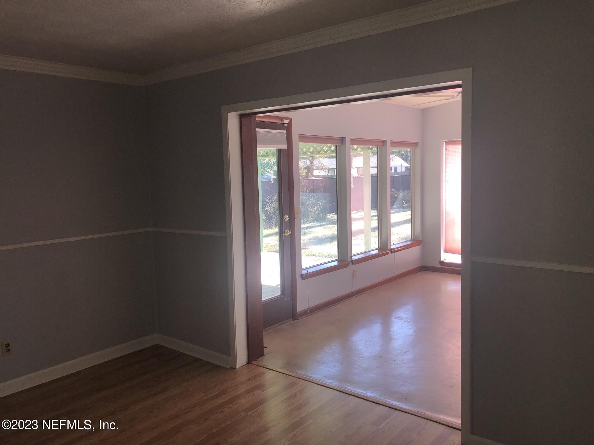 326 Blake Avenue Orange Park, FL 32073 - Photo 8 of 25 an empty room with wooden floor and windows