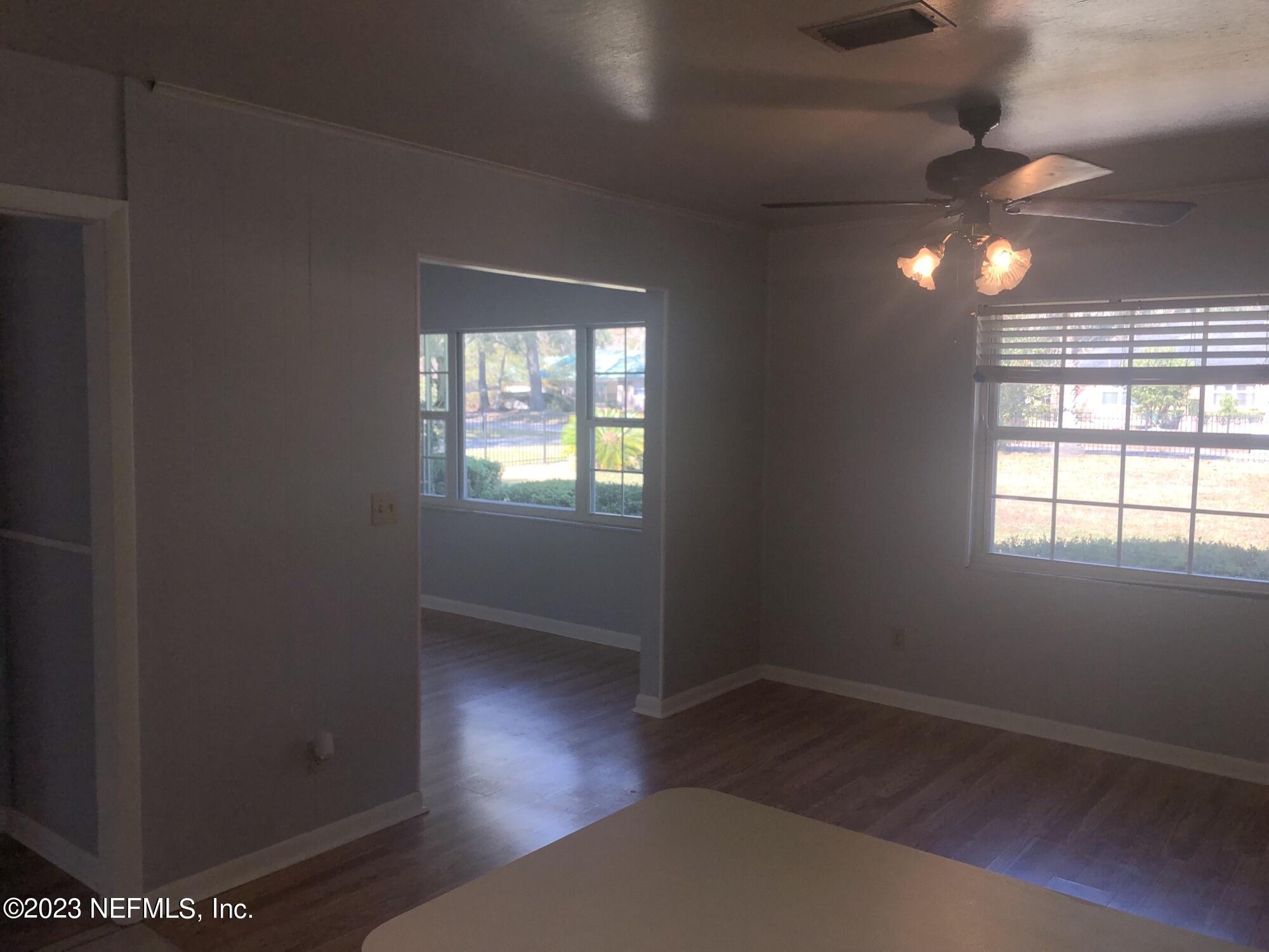 326 Blake Avenue Orange Park, FL 32073 - Photo 9 of 25 an empty room with wooden floor and windows
