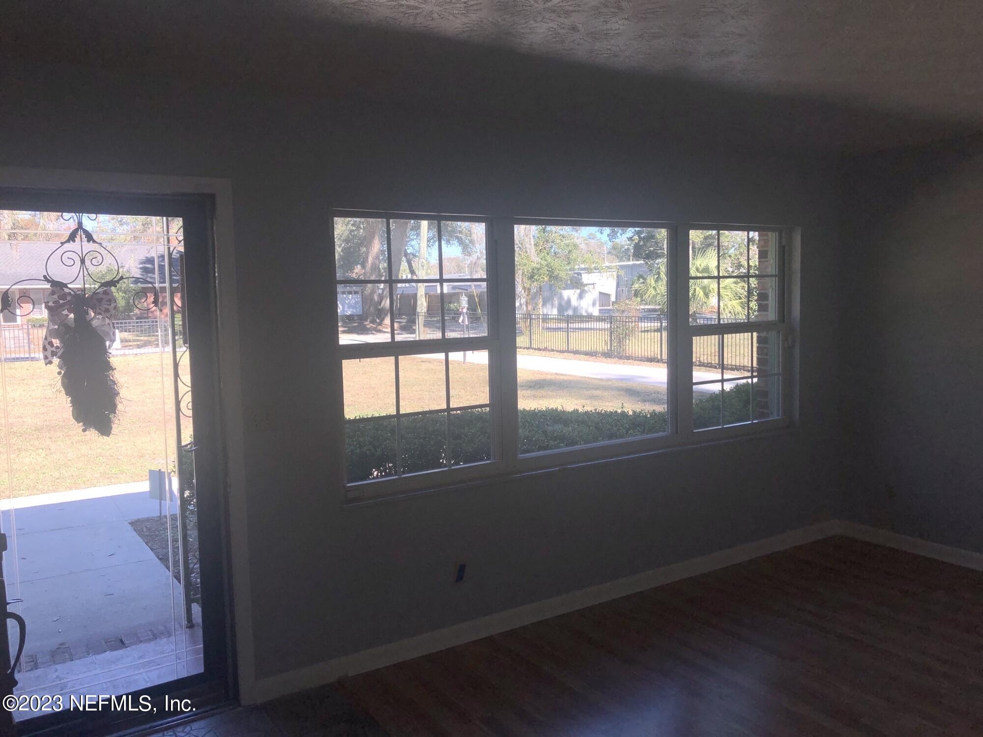 326 Blake Avenue Orange Park, FL 32073 - Photo 10 of 25 an empty room with wooden floor and windows