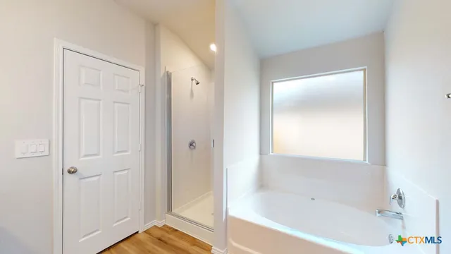 a bathroom with a tub shower and a sink