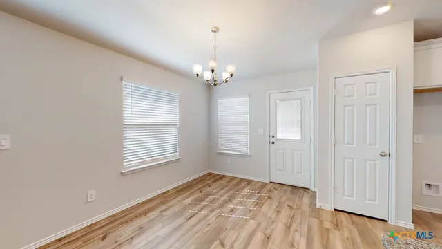 a view of a room with wooden floor and windows