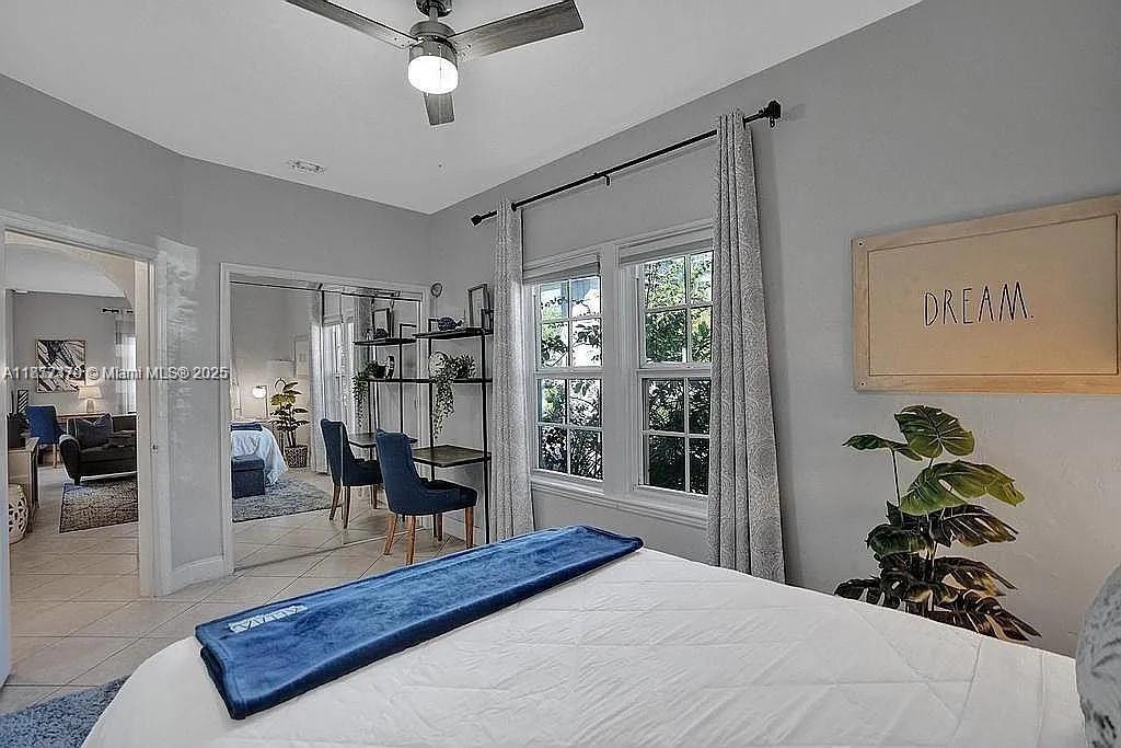 8900 Harding Avenue Surfside, FL 33154 - Photo 17 of 25 a bedroom with a large bed and a chandelier