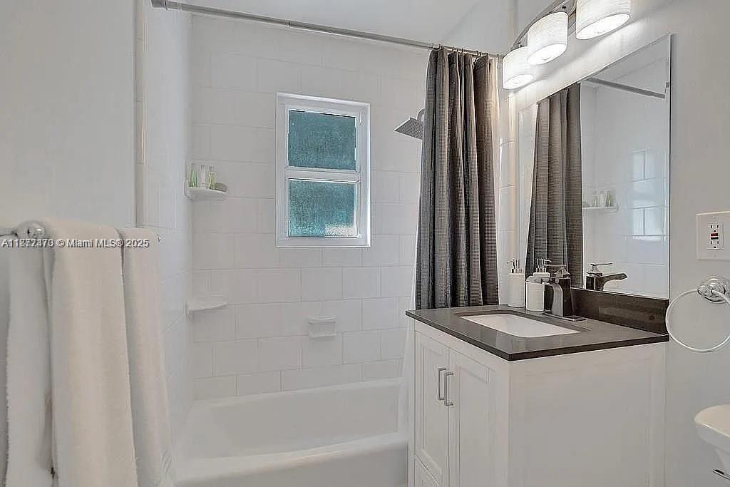 8900 Harding Avenue Surfside, FL 33154 - Photo 20 of 25 a bathroom with a bathtub and a sink