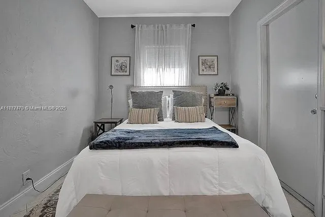 a bedroom with a bed and window