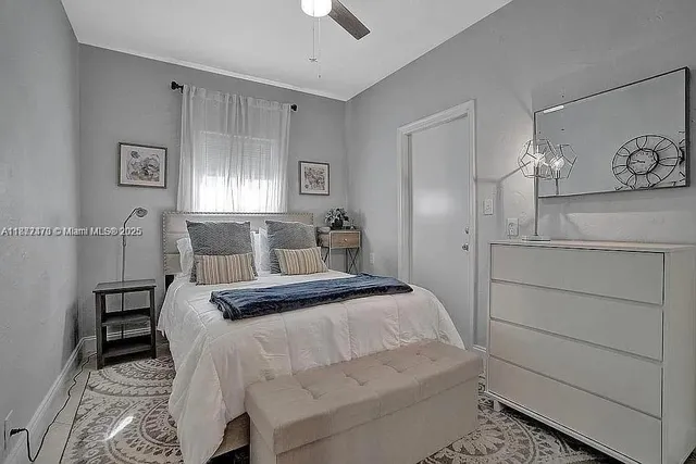 a bedroom with a bed and window