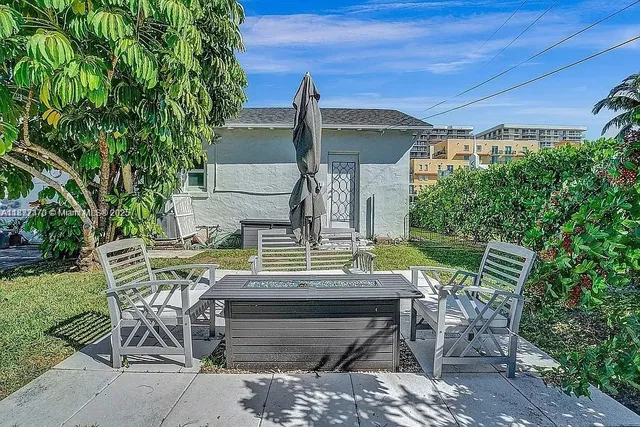 a view of a patio with table and chairs and potted plants
