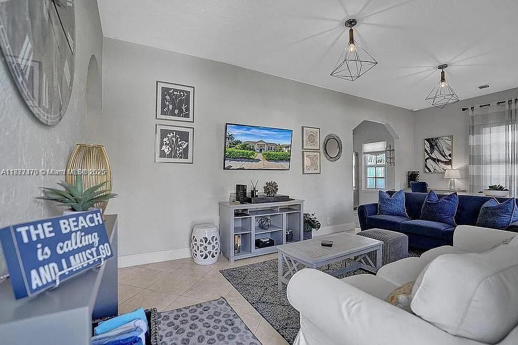 8900 Harding Avenue Surfside, FL 33154 - Photo 7 of 25 a living room with furniture a couch and a window