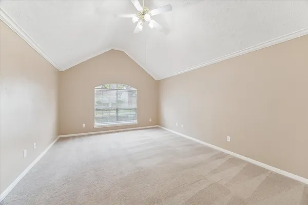 a view of an empty room with a ceiling fan