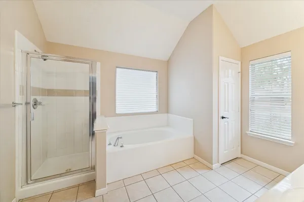 a bathroom with a bathtub sink and mirror