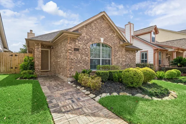 a front view of a house with garden