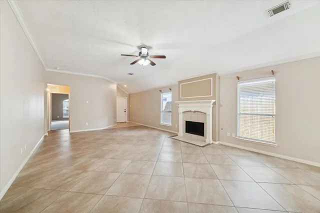 a view of a livingroom with a fireplace and window