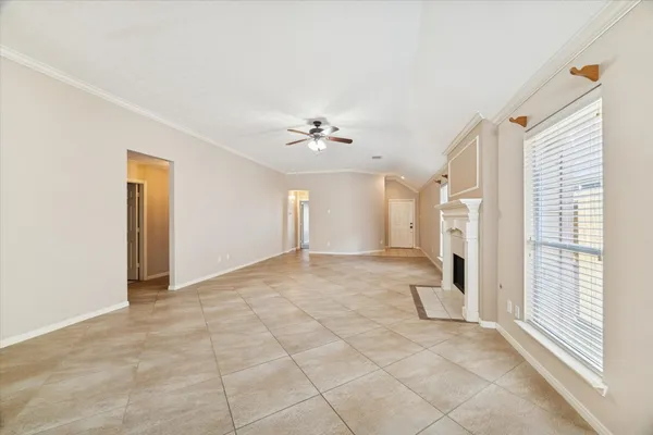 a view of a livingroom with a ceiling fan and window